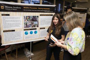 A student presenting her poster.