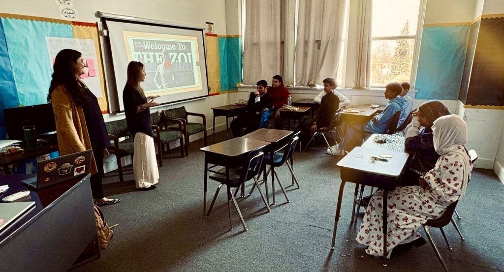 Amelia Howser and Kathryn Fishman-Weaver work with students at the International Islamic Academy