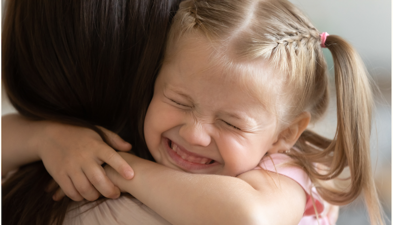 A child hugging someone.